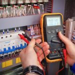 Electrician working with multimeter
